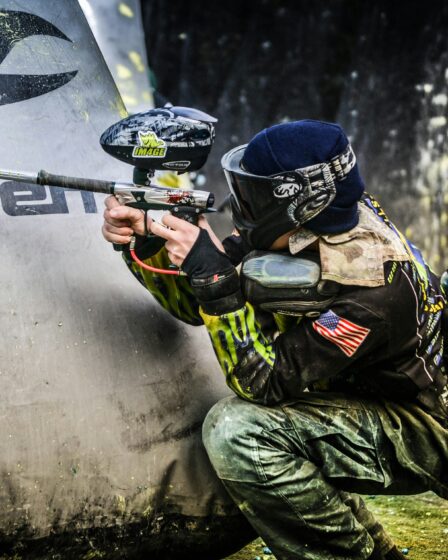 mężczyzna trzymający pistolet do paintballa